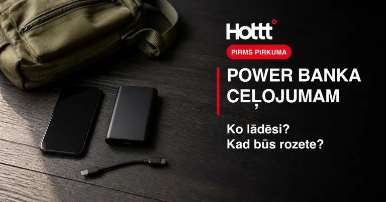 Telefons, power banka un uzlādes vads blakus ceļojuma somai.